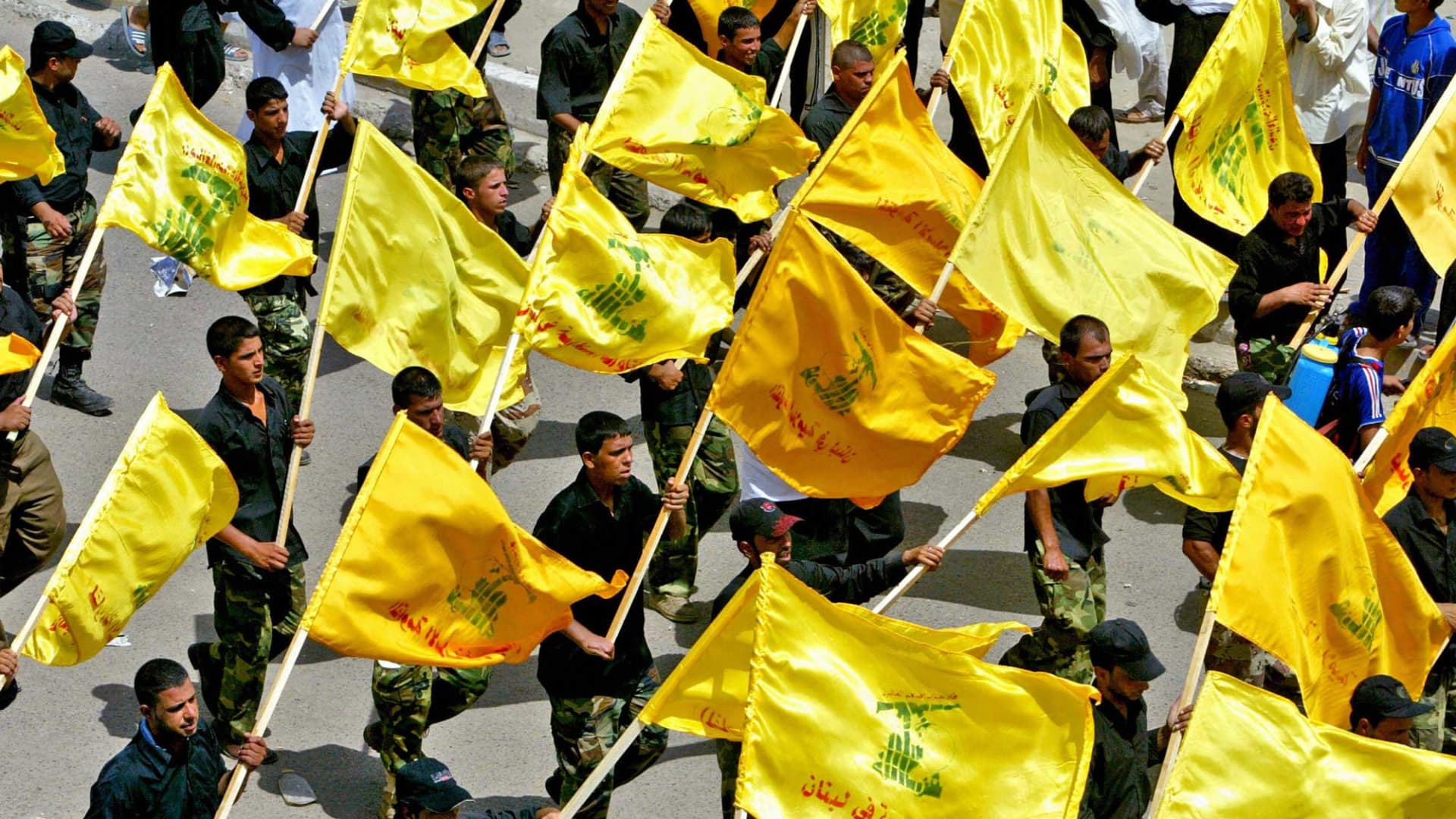 Members of the Shiite Mehdi army militia carry Lebanese Hezbollah flags as they rally in Baghdad's neighborhood of Sadr City in 2006.