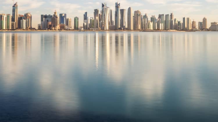 What does Qatar own around the world?