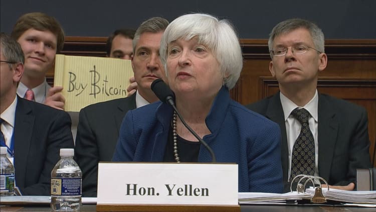 Someone held up a 'buy bitcoin' sign during Yellen's testimony to Congress