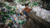 A boy works at a plastic bottle recycling centre by the river Buriganga in Dhaka.