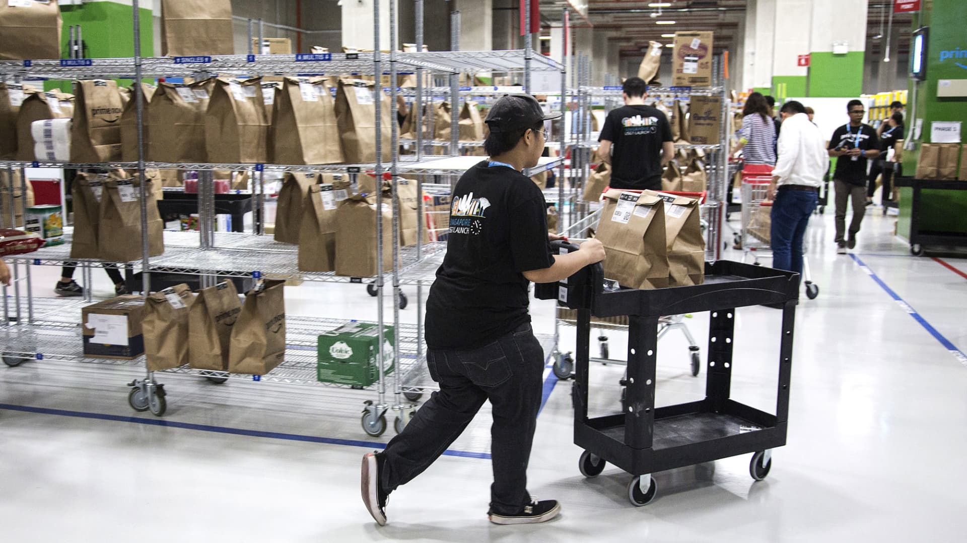 Employees prepare orders for shipping at Amazon.com Inc.'s Amazon Prime Now fulfillment center in Singapore, on Thursday, July 27, 2017.
