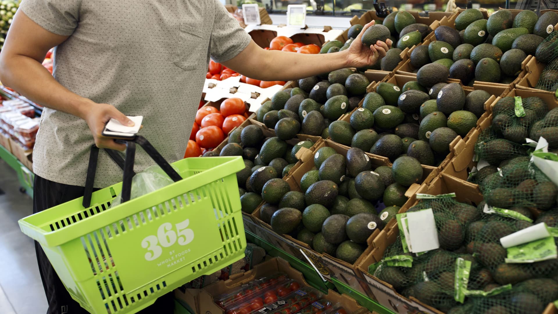 A customer browses avocados at a Whole Foods Market 365 location in Santa Monica, California.
