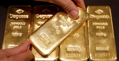 Gold hits highest in more than a week; dollar, stocks retreat
