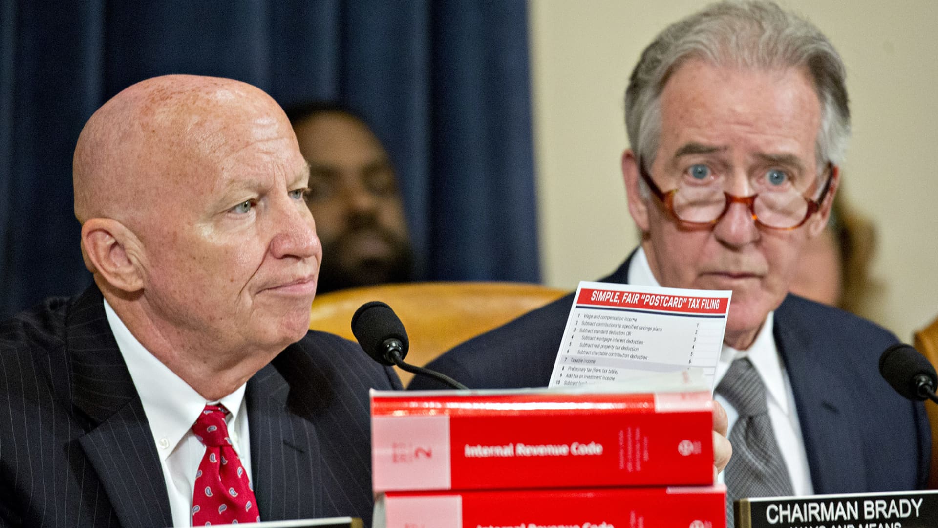 Chairman of the House Ways and Means Committee Rep. Kevin Brady, R-Texas, left, holds up a 'Simple, Fair 'Postcard' Tax Filing' card next to ranking member Rep. Richard Neal, D-Mass., during a markup hearing in Washington, D.C., on Nov. 6, 2017.