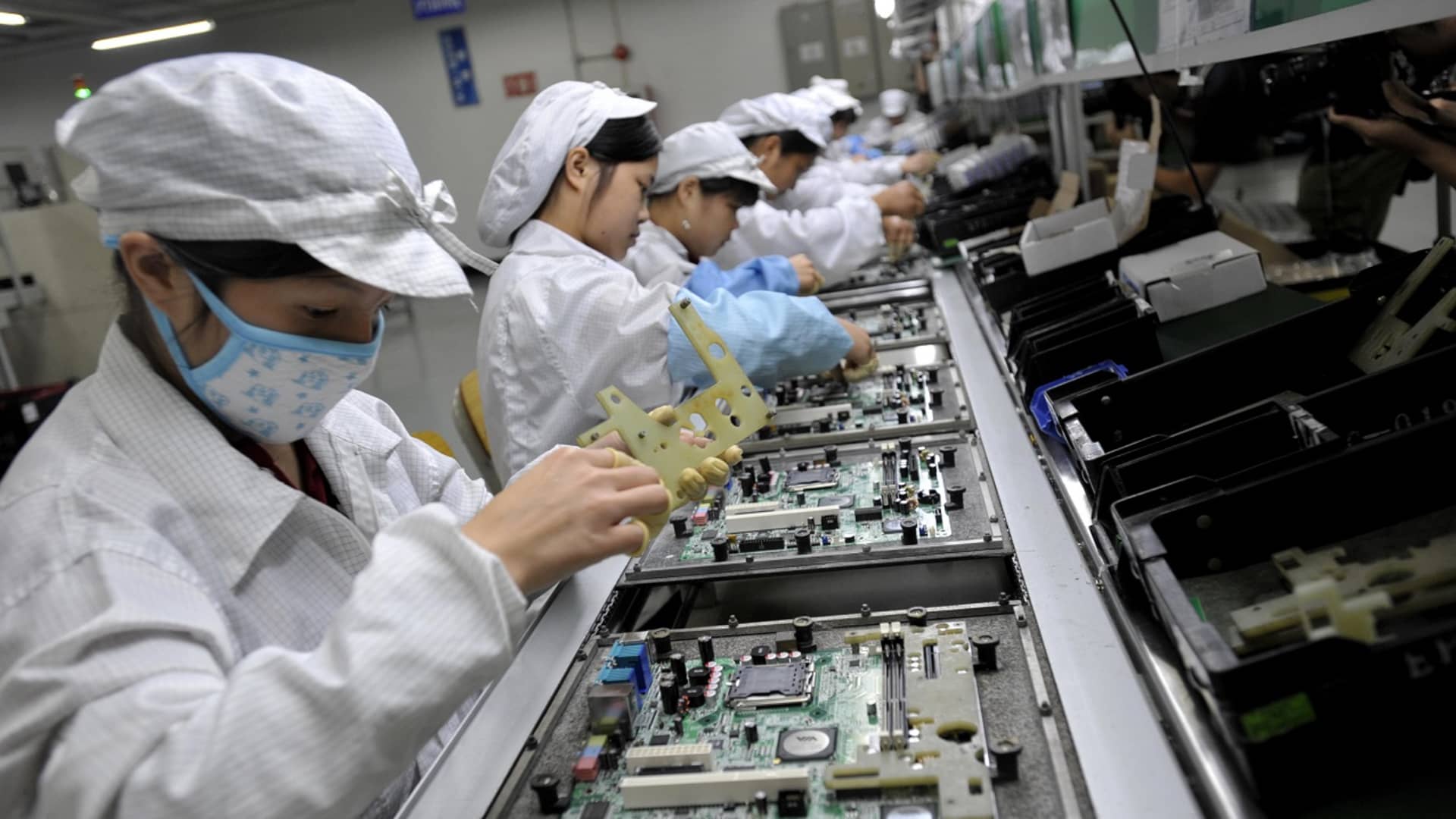 Chinese workers assemble electronic components at the Taiwanese technology giant Foxconn's factory in Shenzhen, China.