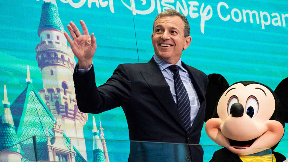 Chief executive officer and chairman of The Walt Disney Company Bob Iger and Mickey Mouse look on before ringing the opening bell at the New York Stock Exchange, November 27, 2017 in New York City.