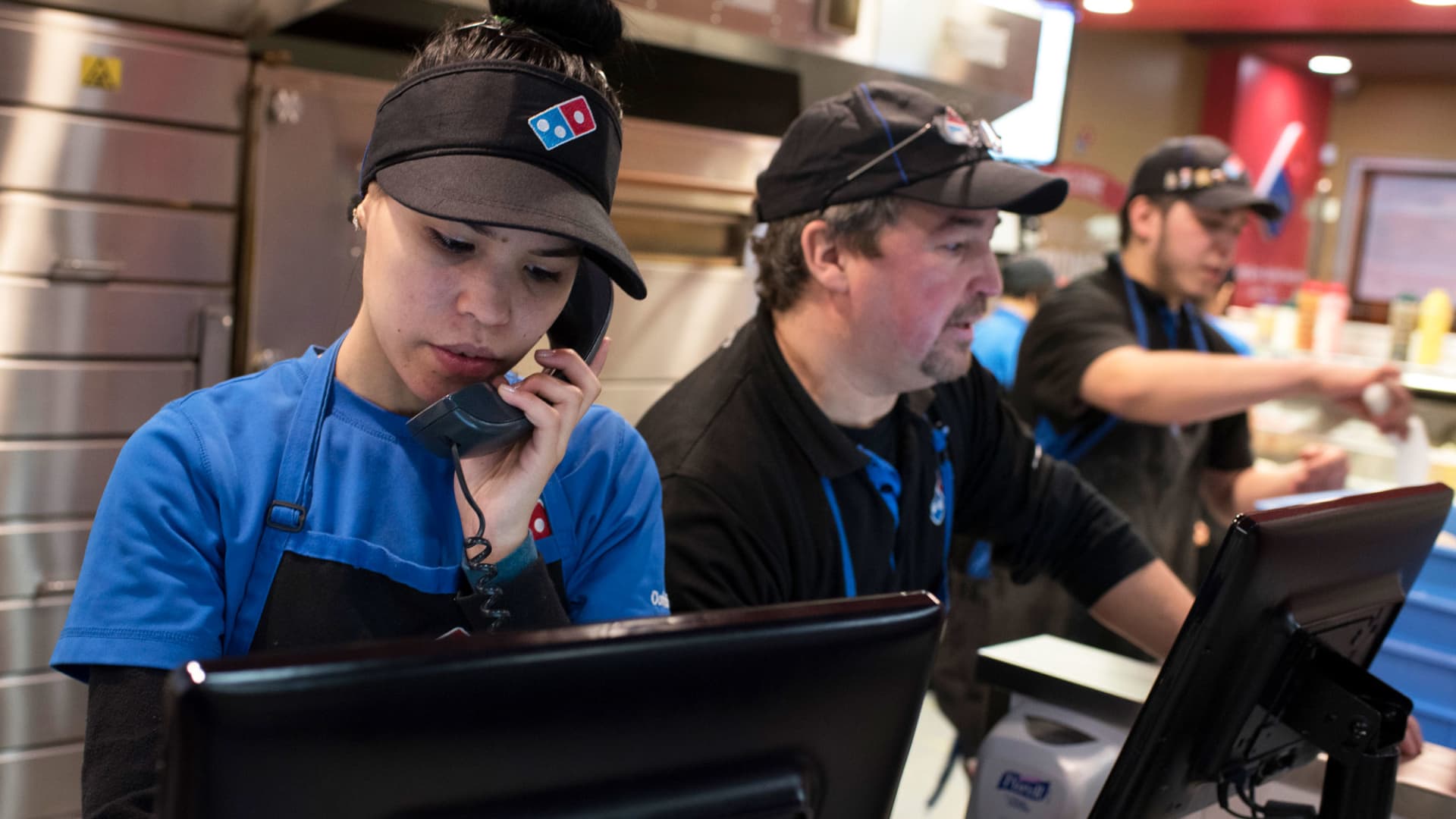 An employee takes an order on the phone at a Domino's Pizza in Jersey City, New Jersey.