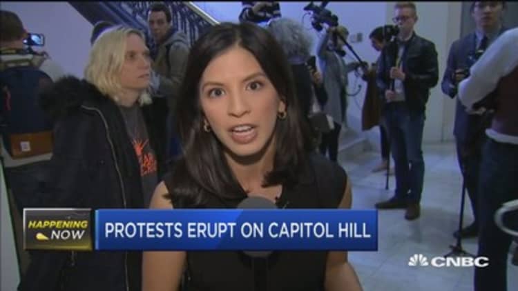Protests erupt on Capitol Hill over tax bill