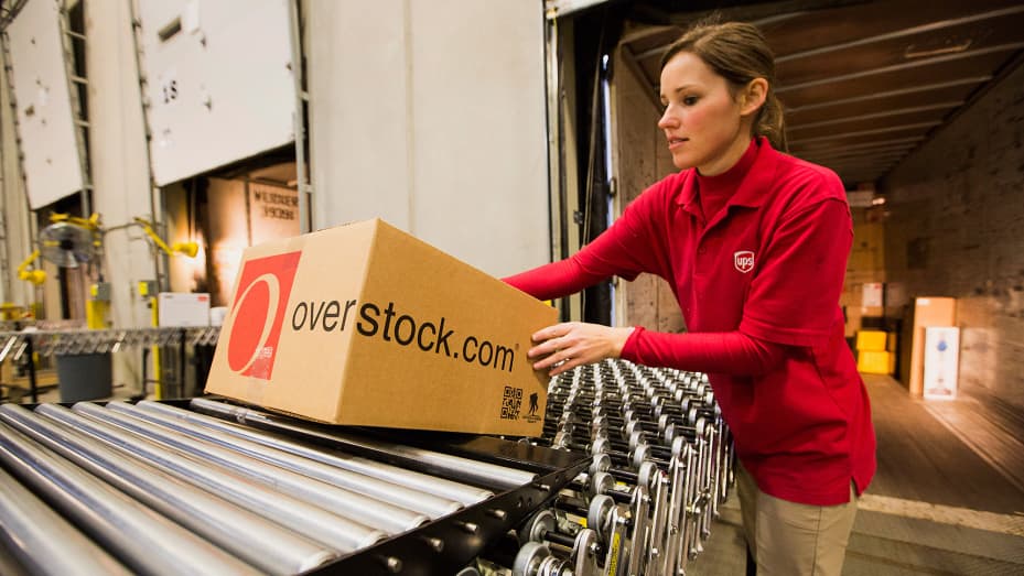 A United Parcel Service worker loads orders onto a truck in the shipping area at the Overstock.com distribution center in Salt Lake City, Utah.