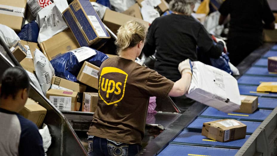 کارمندان بسته‌ها را در مرکز تثبیت منطقه شیکاگو (UPS) در هاجکینز، ایلینویز مرتب می‌کنند.
