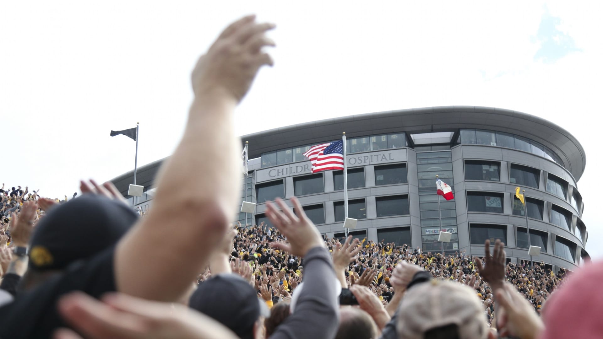 Fans wave to children at the University of Iowa Stead Family Children's Hospital during the Iowa football game at Kinnick Stadium in Iowa City, Iowa.