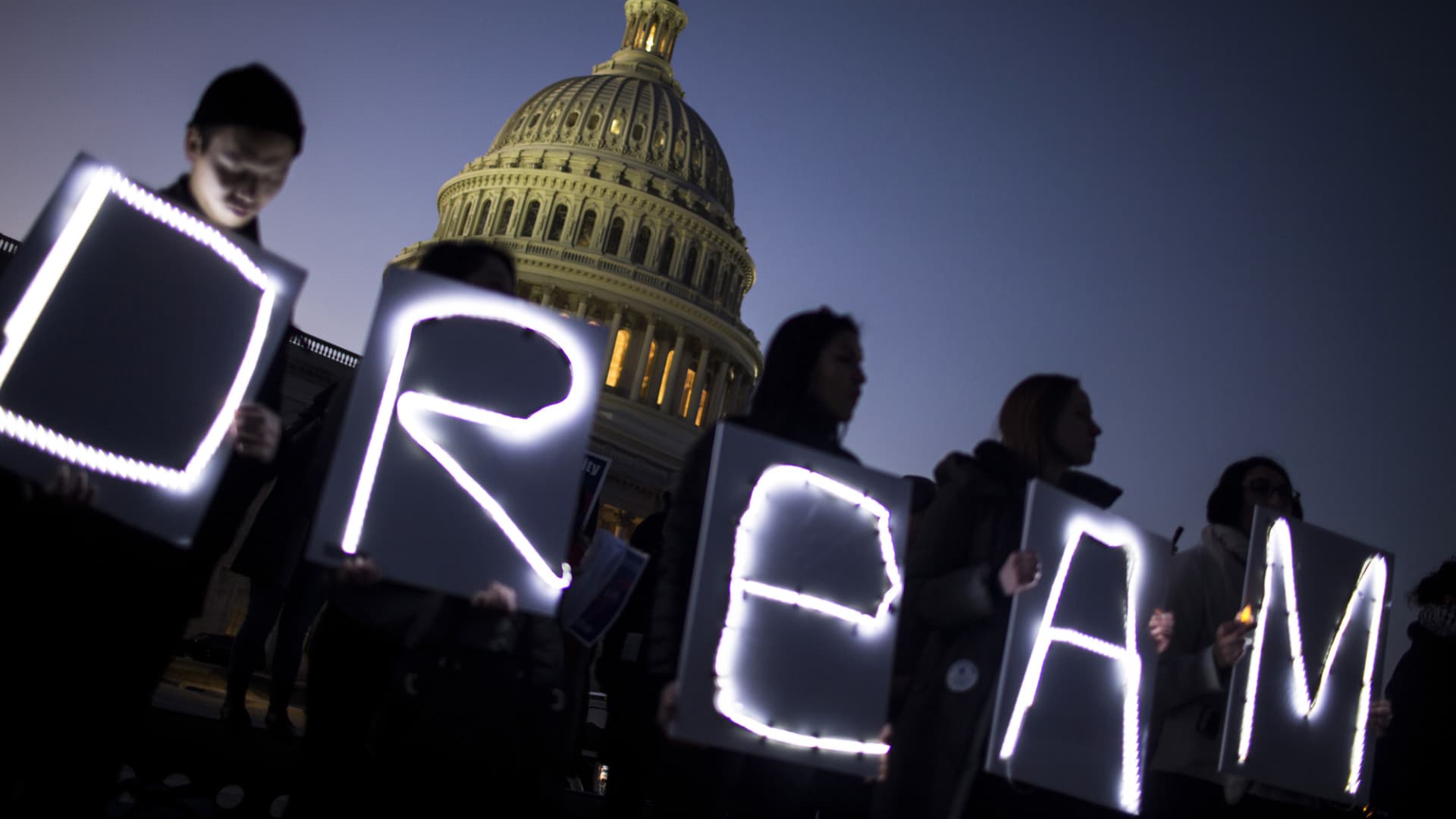Demonstrators hold illuminated signs during a rally supporting the Deferred Action for Childhood Arrivals program (DACA), or the Dream Act, outside the U.S. Capitol building in Washington, D.C., Jan. 18, 2018.