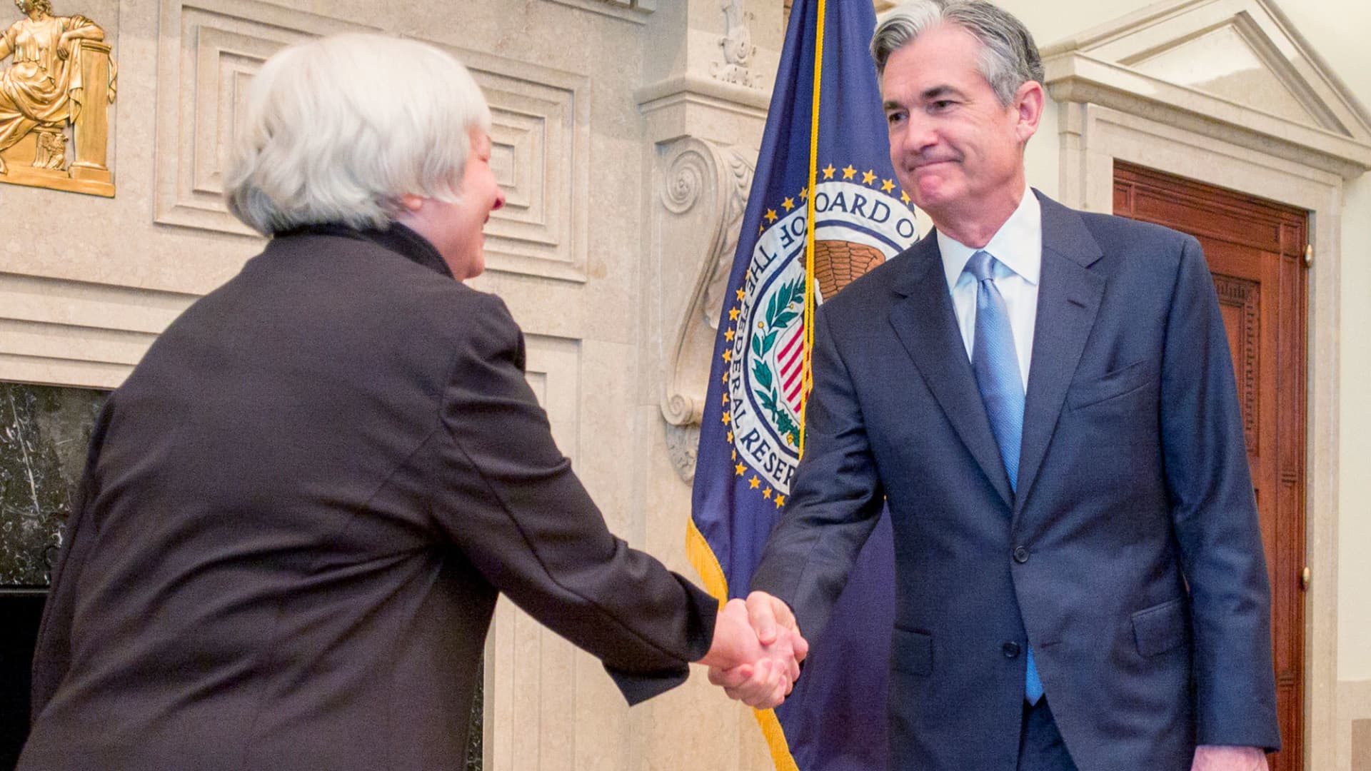 Federal Reserve Chair Janet Yellen (L) congratulates Fed Governor Jerome Powell at his swearing-in ceremony for a new term on the Fed's board, in Washington in this handout photo taken and released June 16, 2014.