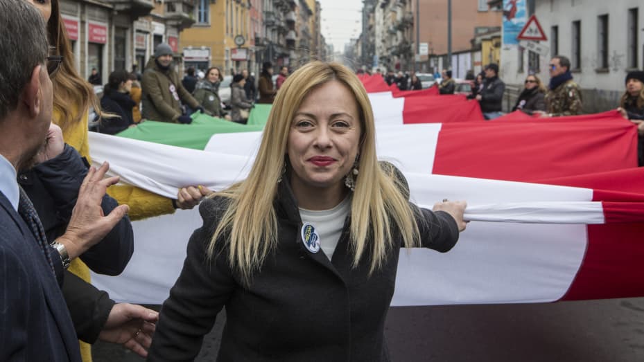 Giorgia Meloni, leader of the right-wing party Fratelli d'Italia (Brothers of Italy) holds a giant Italian national flag during a political rally on February 24, 2018 in Milan, Italy.