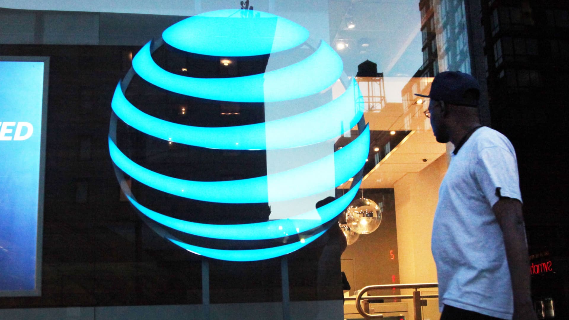 A pedestrian walks in front of an AT&T location in New York.