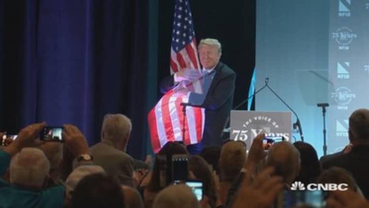 Trump embraces American flag after NFIB speech