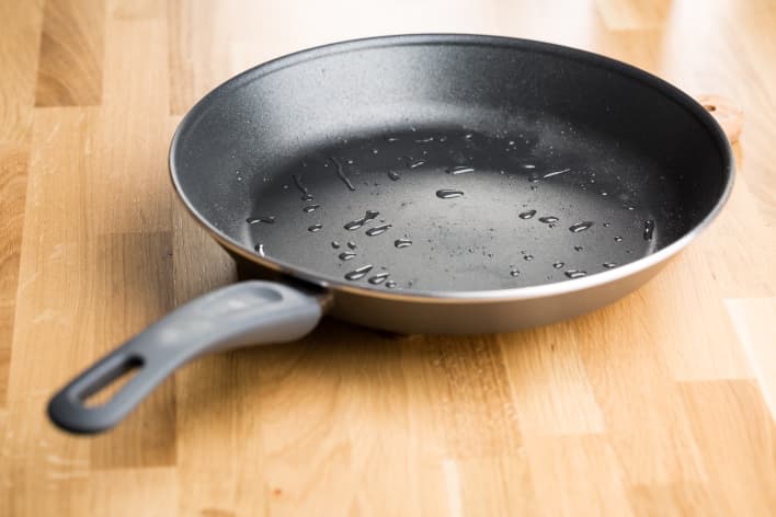 GP: Teflon frying pan on wooden table