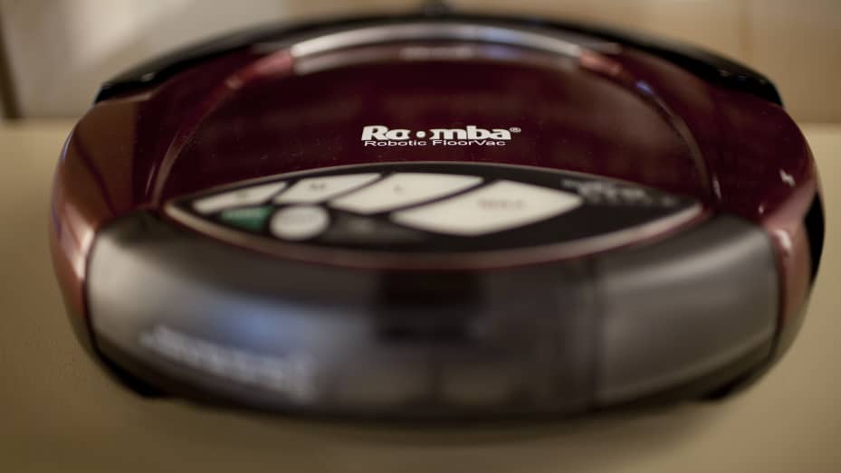 A vacuuming Roomba model robot is displayed at iRobot headquarters in Bedford, Massachusetts