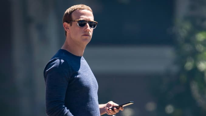 Mark Zuckerberg, chief executive officer and founder of Facebook, holds his phone after the morning session at the Allen & Co. Media and Technology Conference in Sun Valley, Idaho, July 13, 2018.