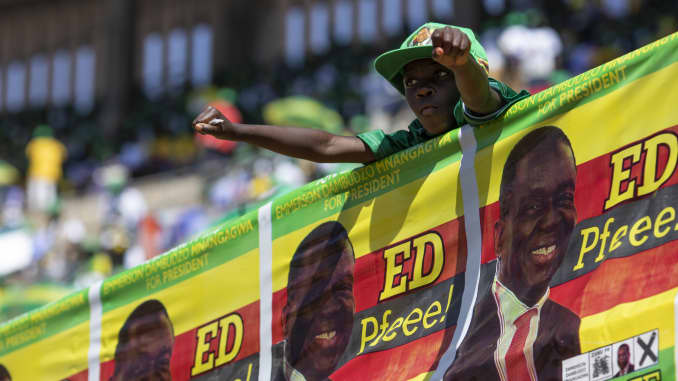 A young supporter waits for Zimbabwe's President Emmerson Mnangagwa to arrive for his final campaign rally on July 28, 2018, in Harare, Zimbabwe.