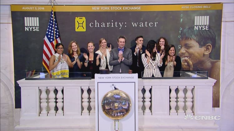 Officials and guests of the charity: water, ring Friday's closing bell at the NYSE