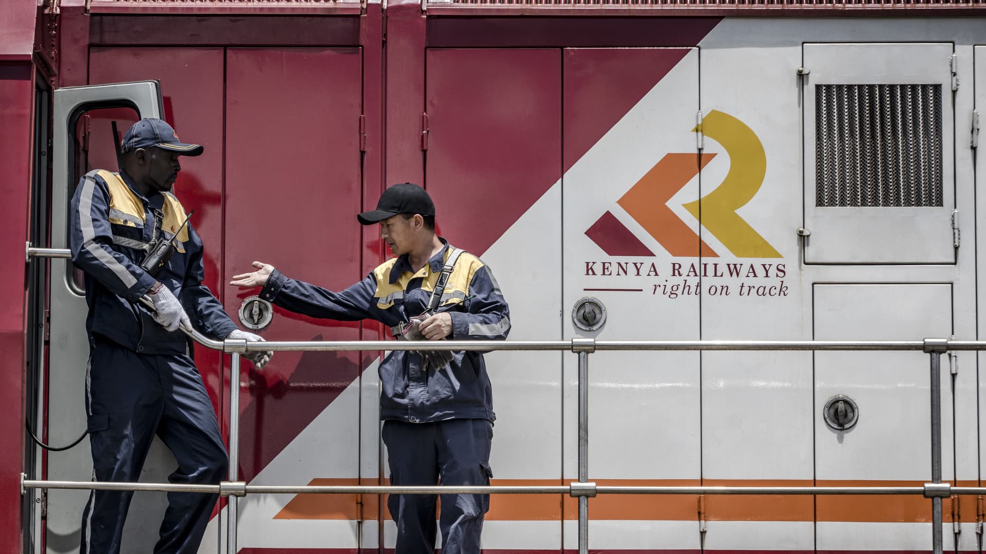 Railway workers inspect a Kenya Railways freight train before departure from the port station in Mombasa, Kenya, on Saturday, Sept. 1, 2018.