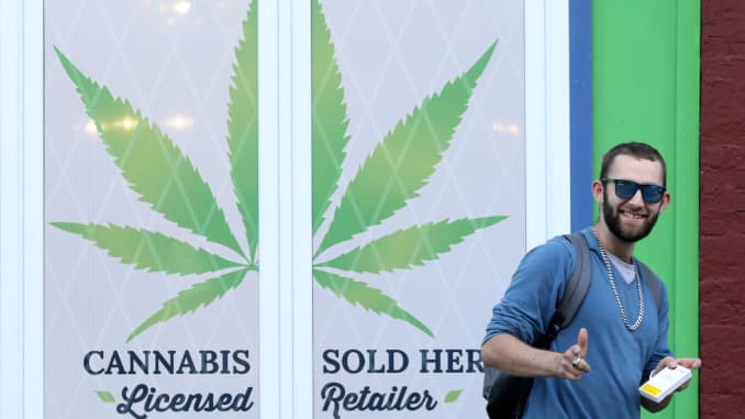 A customer holding a cannabis product gestures while leaving the Natural Vibe store after legal recreational marijuana went on sale in St John's, Newfoundland and Labrador, Canada October 17, 2018. 