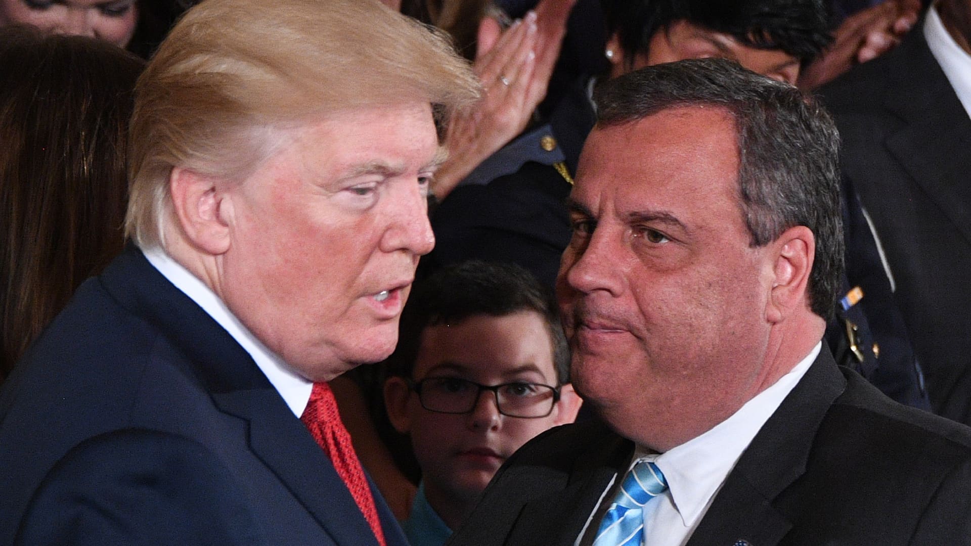 US President Donald Trump (L) speaks with Governor Chris Christie (R-NJ) after he delivered remarks on combatting drug demand and the opioid crisis on October 26, 2017 in the East Room of the White House in Washington, DC.