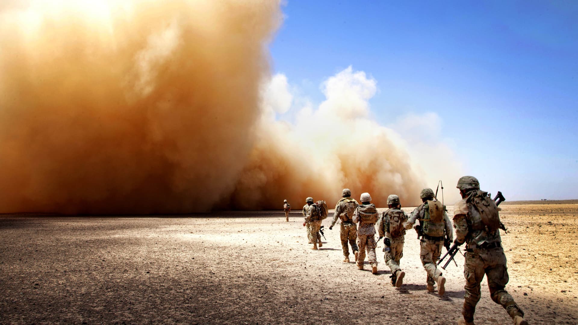 U.S. Marines and Georgian Army soldiers run to the extraction point during Operation Northern Lion II in Helmand province, Afghanistan, July 3, 2013.