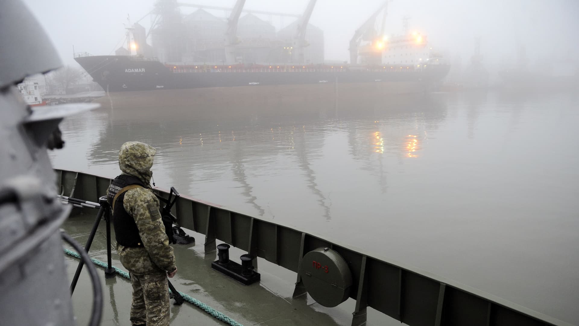 Ukrainian soldier stands guard aboard military boat called 'Dondass' moored in Mariupol, Sea of Azov port on November 27, 2018. - Three Ukrainian navy vessels were seized off the coast of Crimea by Russian forces, which fired on and boarded Kiev's ships after several tense hours of confrontation. Here's what is known about Sunday's incident.