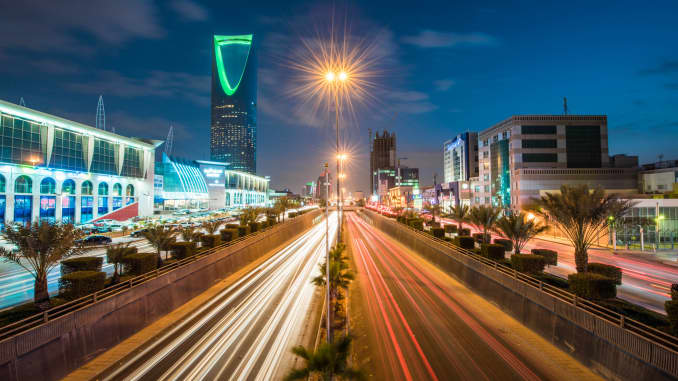 The Kingdom Tower, operated by Kingdom Holding, left, stands alongside the King Fahd highway, illuminated by the light trails of passing traffic, in Riyadh, Saudi Arabia, on Saturday, Jan. 9, 2016. 