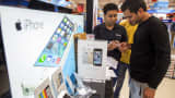 A customer views an Apple Inc. iPhone 5s at a Reliance Digital store, a subsidiary of Reliance Industries Ltd., in New Delhi, India, on Saturday, Nov. 2, 2013. Reliance Communications Ltd. is the first Indian carrier to sell Apples iPhone with a service contract. Reliance will offer customers the iPhone 5S and 5C a two-year contract with bundled data services. Photographer: Prashanth Vishwanathan/Bloomberg via Getty Images
