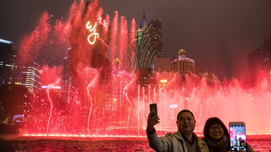 People use their smartphones to take photographs outside The Wynn Macau casino resort, operated by Wynn Resorts Ltd., in Macao, China, on Tuesday, Jan. 30, 2018.