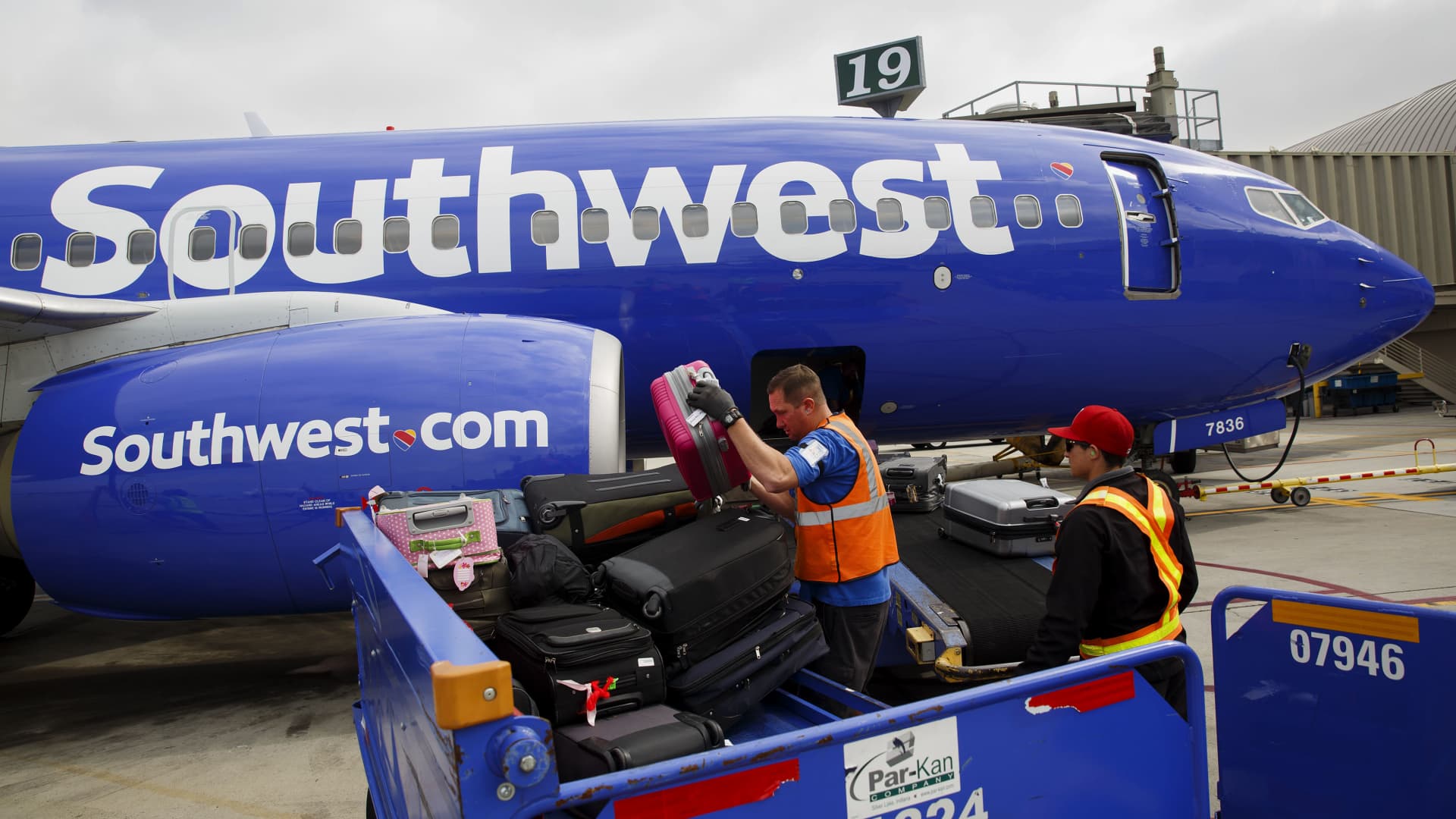 Ground operations employees load baggage onto a Southwest Airlines Boeing 737 aircraft on the tarmac at John Wayne Airport in Santa Ana, California.