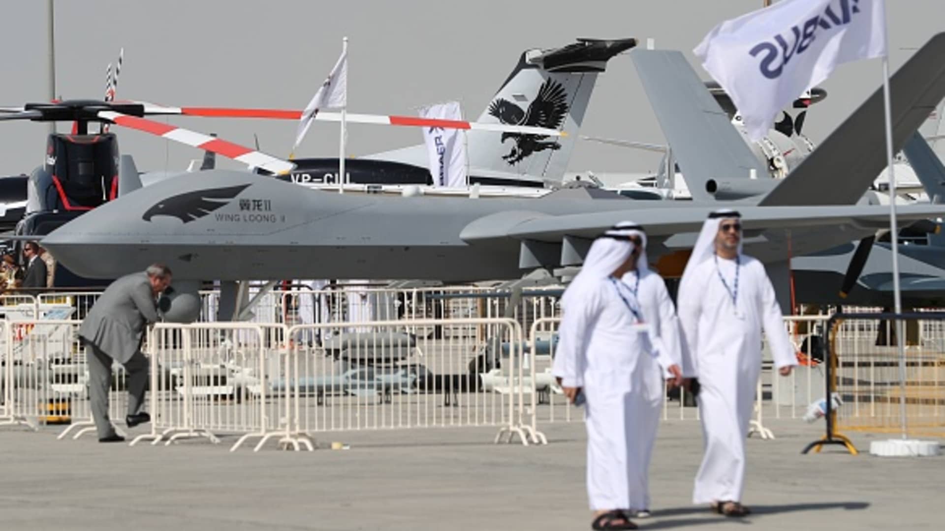 Participants walk past a Chinese made Wing Loong drone displayed during the Dubai Airshow on November 14, 2017, in the United Arab Emirates.