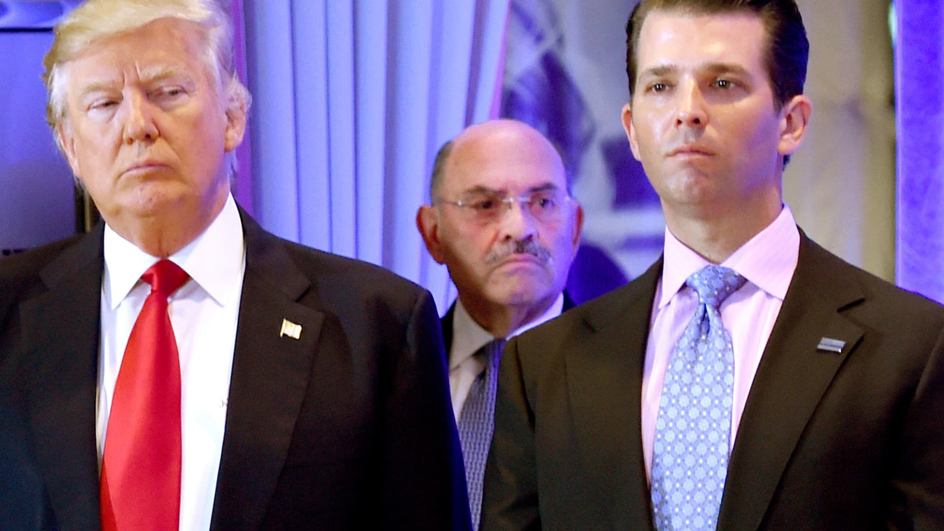 US President-elect Donald Trump along with his son Donald, Jr., arrive for a press conference at Trump Tower in New York, as Allen Weisselberg (C), chief financial officer of The Trump, looks on.