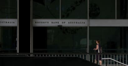 Australia's central bank opens door to earlier rate rise, pledges patience 