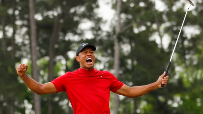 Tiger Woods of the United States celebrates after sinking his putt on the 18th green to win during the final round of the Masters at Augusta National Golf Club on April 14, 2019 in Augusta, Georgia.