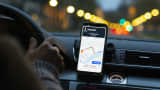 A dashboard-mounted smartphone displays a map on the Uber Technologies app.