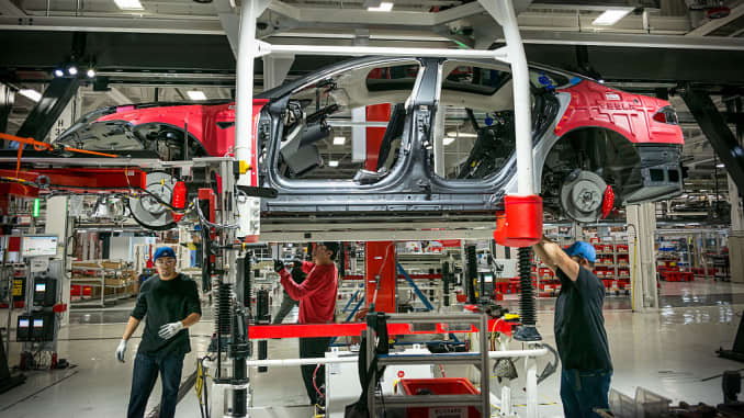 Workers assemble cars on the line at Tesla's factory in Fremont. David Butow (Photo by David Butow/Corbis via Getty Images)