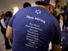 A job recruiter wears a shirt showing all of the Wal-Mart Stores Inc. brands during a career fair at the Sheraton Hotel in Philadelphia, Pennsylvania.
