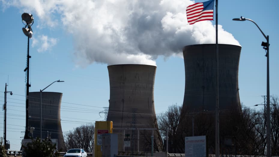 An employee leaves in his car from the nuclear plant on Three Mile Island, with the operational plant run by Exelon Generation on the right, in Middletown, Pennsylvania on March 26, 2019.