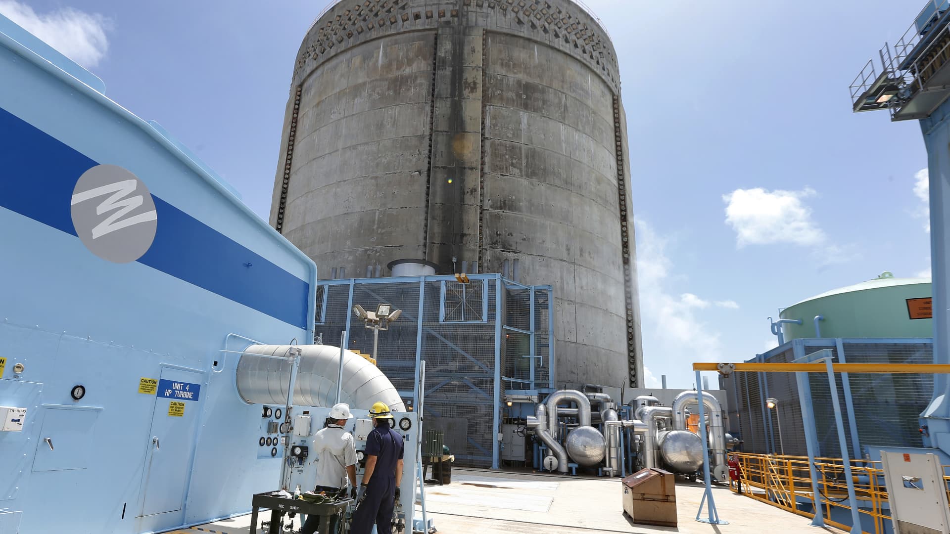 Florida Power and Light workers Juan Madruga (R) and Pehter Rodriguez (L) confer at the Turkey Point Nuclear Reactor Building in Homestead, Florida May 18, 2017.