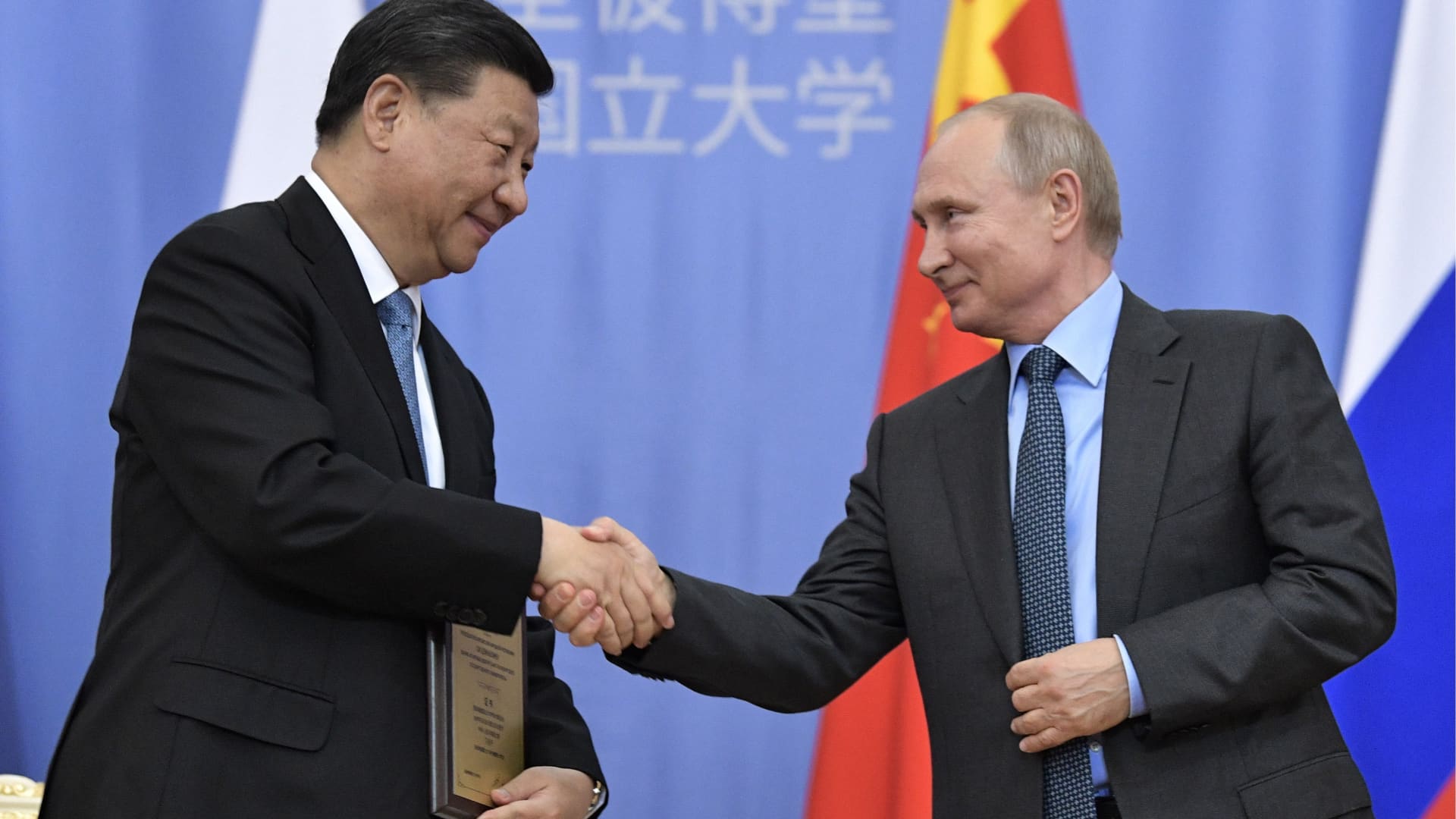 ST PETERSBURG, RUSSIA - JUNE 6, 2019: China's Persident Xi Jinping (L) and Russia's President Vladimir Putin shake hands at a ceremony at St Petersburg University in which Xi Jinping was awarded St Petersburg University honorary doctoral degree.