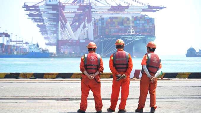 Workers stand at the port of Qingdao, Shandong province, China June 10, 2019.