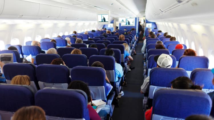Why do airlines overbook flights?