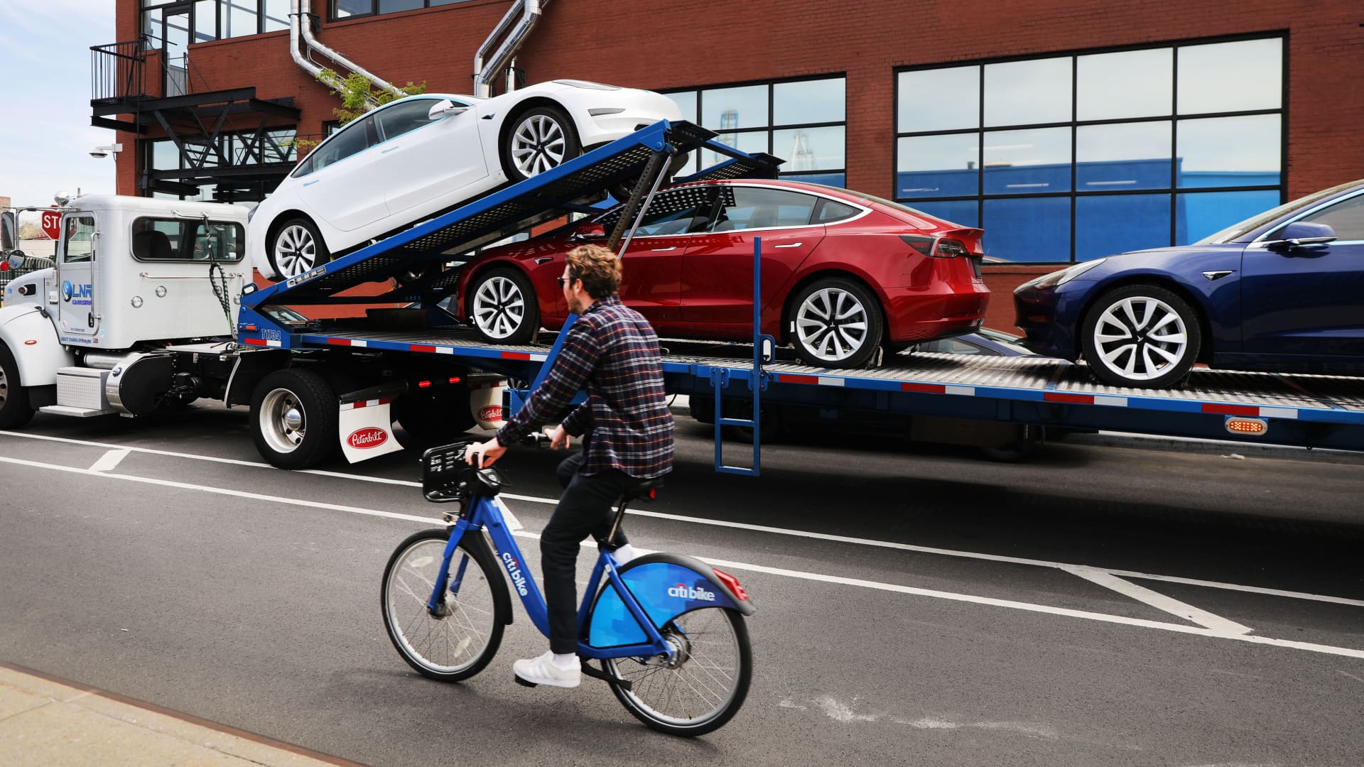 Tesla cars are delivered to a showroom in Brooklyn, New York on April 25, 2019.