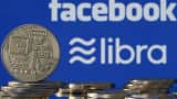 A visual representation of digital cryptocurrency coins on display in front of Facebook and Libra logos.