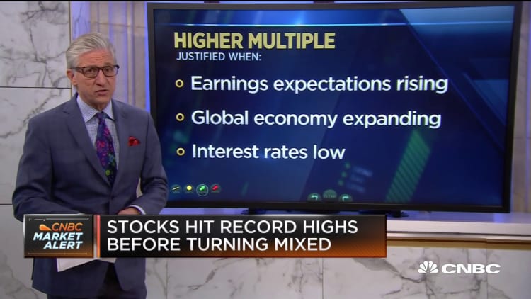 Stocks hit record highs at open before turning mixed