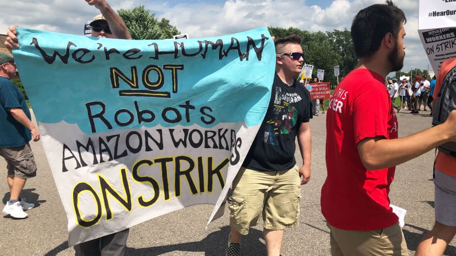 Amazon facility workers hold a sign during a protest in Shakopee, Minnesota, July 15, 2019.